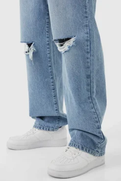Shop boohooMAN Baggy Rigid Distressed Jeans ice blue