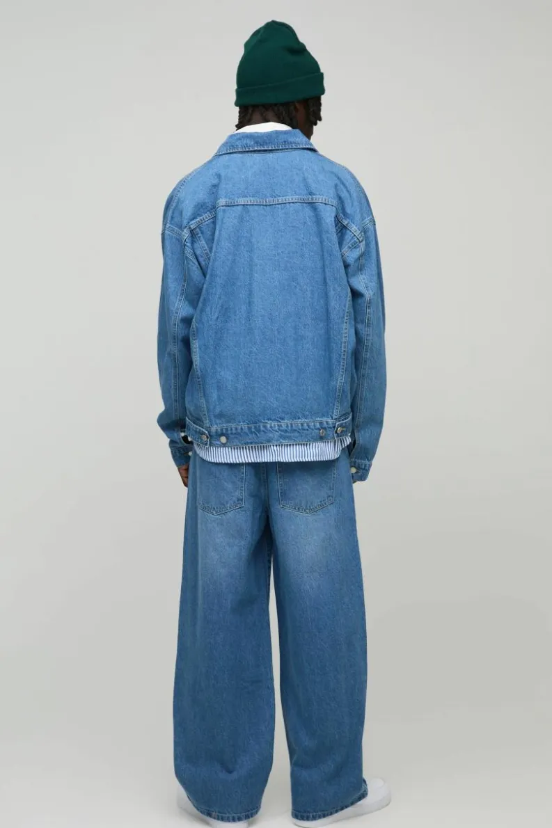 Shop boohooMAN Belted Baggy Fit Jeans light wash