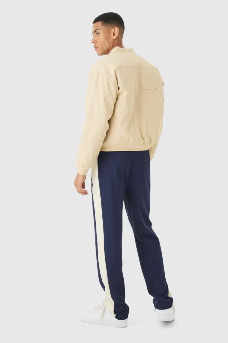 Shop boohooMAN Boxy OFCL Applique Twill Padded Bomber Jacket In stone