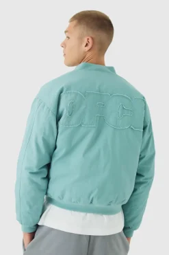 Fashion boohooMAN Boxy OFCL Applique Twill Padded Bomber Jacket In light blue