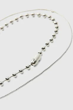 Shop boohooMAN Cross Pendant Double Layered Necklace In silver