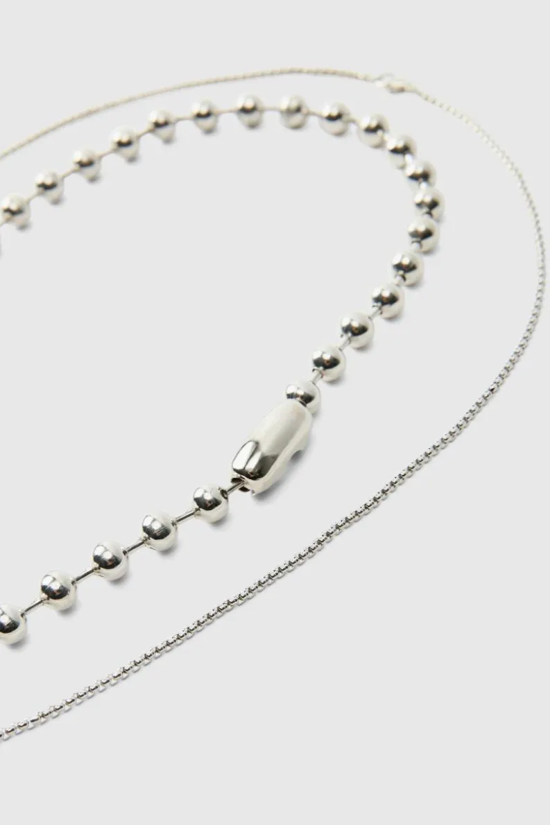 Shop boohooMAN Cross Pendant Double Layered Necklace In silver