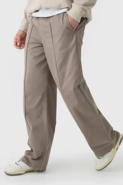 Shop boohooMAN Elasticated Waist Wide Leg Pintuck Chino Trousers taupe