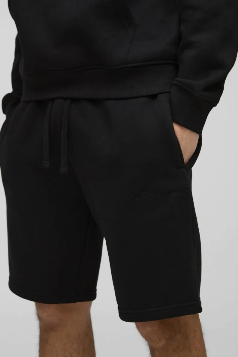 Shop boohooMAN Loose Fit Mid Length BM Signature Shorts black