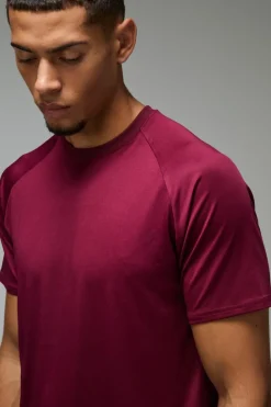 Shop boohooMAN Man Active Lightweight Essentials Gym Raglan T-shirt burgundy