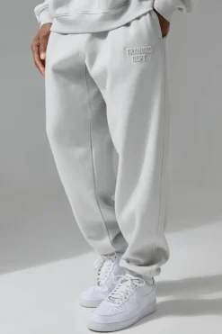 Cheap boohooMAN Man Active Training Dept Oversized Embossed Jogger light grey