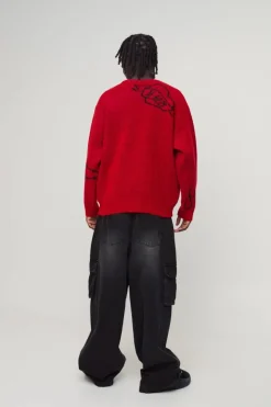 Shop boohooMAN Oversized Boxy Brushed Multi Doodle Graphic Knitted Jumper red