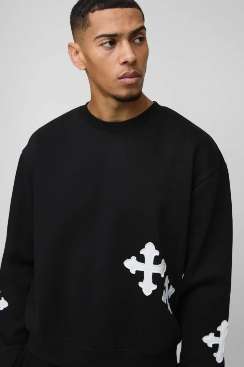 Shop boohooMAN Oversized Boxy Gothic Cross Applique Sweatshirt black