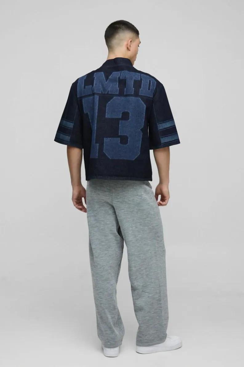 Shop boohooMAN Oversized Boxy V Neck Laser Print Football Top indigo