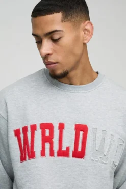 Shop boohooMAN Oversized Boxy Worldwide Distressed Applique Sweatshirt grey marl