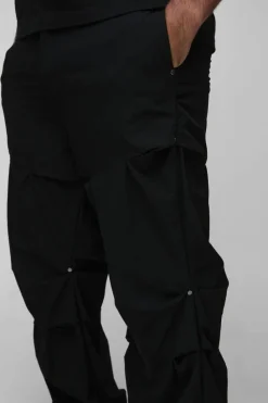 Shop boohooMAN Plus Slim Fit Flare Stacked Trouser With Ruched Detail black