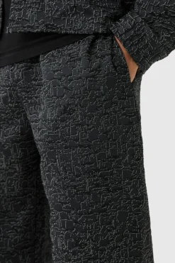 Shop boohooMAN Relaxed Fit Jacquard Abstract Pattern Trouser black