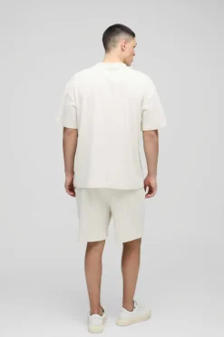 Shop boohooMAN Relaxed Man Embroidered Waffle Shorts ecru