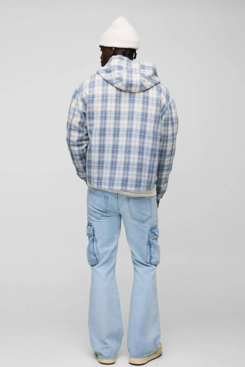 Shop boohooMAN Relaxed Rigid Flare Cargo Denim Jeans light blue