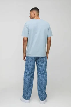 Shop boohooMAN Relaxed Rigid Laser Printed Denim Jeans mid blue