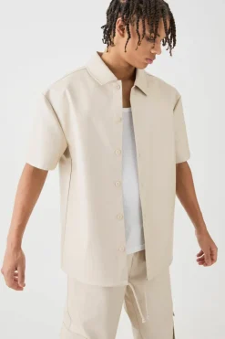 Shop boohooMAN Short Sleeve Drop Shoulder Pu Overshirt & Cargo Trouser Set beige