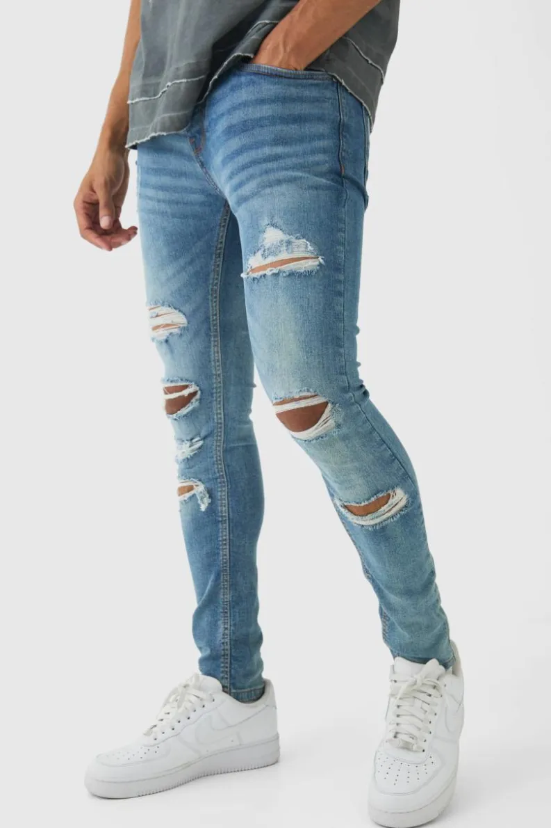 Store boohooMAN Skinny Fit All Over Ripped Jeans light blue