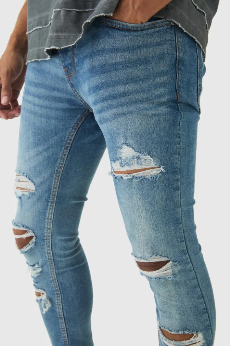 Store boohooMAN Skinny Fit All Over Ripped Jeans light blue