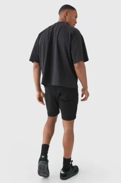Store boohooMAN Skinny Stretch Distressed Denim Shorts In Black true black