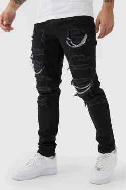 Shop boohooMAN Skinny Stretch Ripped Chain Jeans black