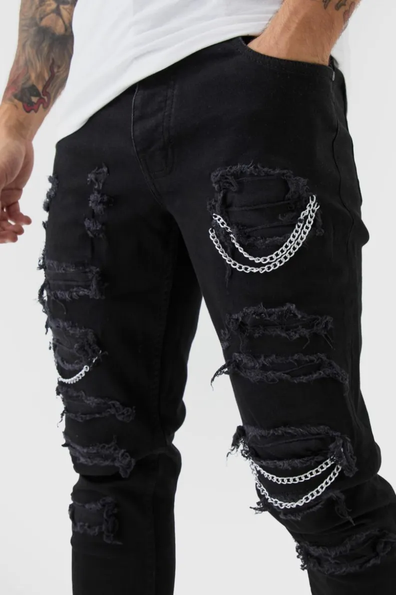 Shop boohooMAN Skinny Stretch Ripped Chain Jeans black