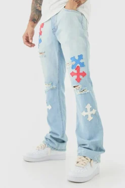 Shop boohooMAN Slim Rigid Flare Applique Jeans In ice blue