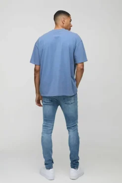 Online boohooMAN Super Distressed Dirty Wash Skinny Jeans mid wash