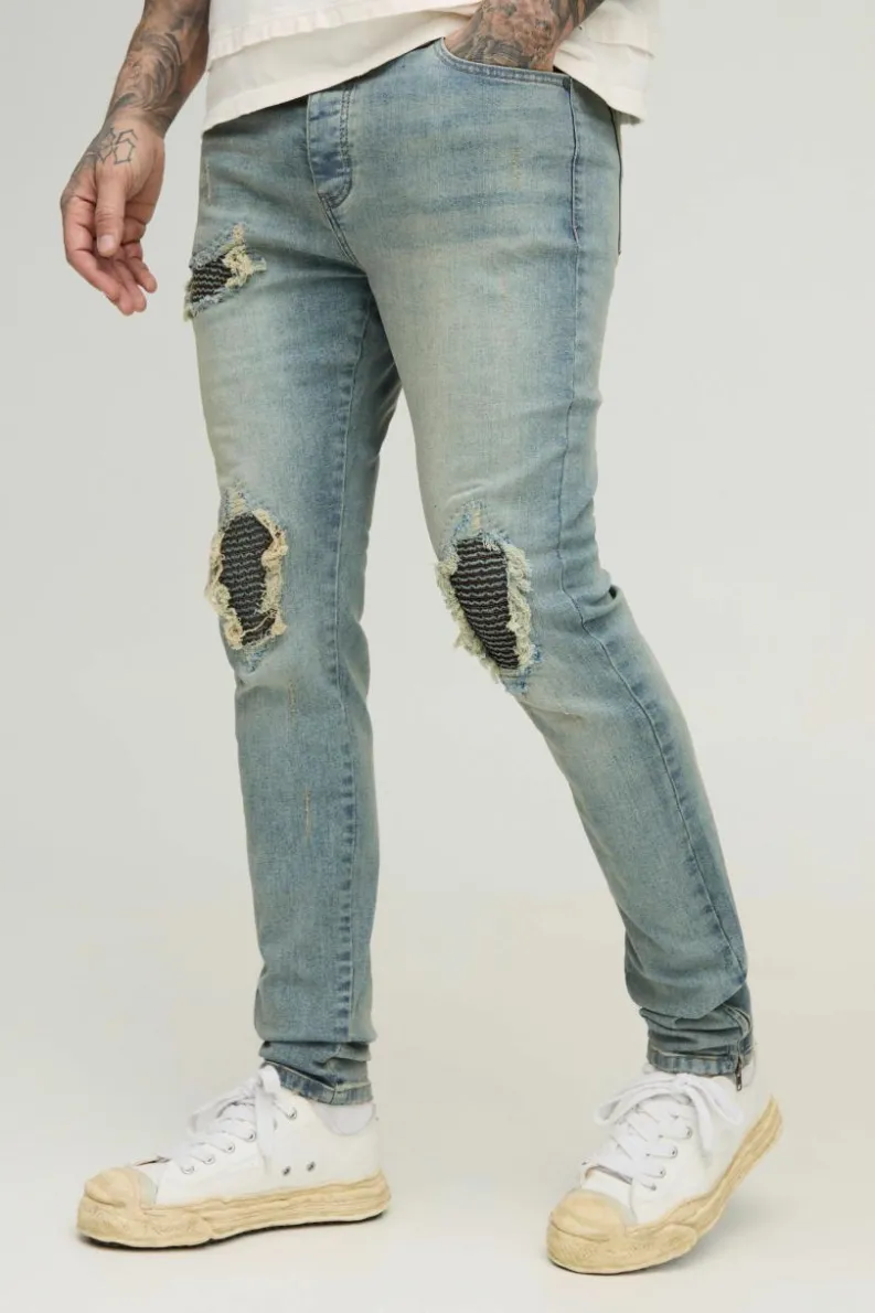 Store boohooMAN Tall Biker Rip & Repair Zip Hem Skinny Jeans stonewash