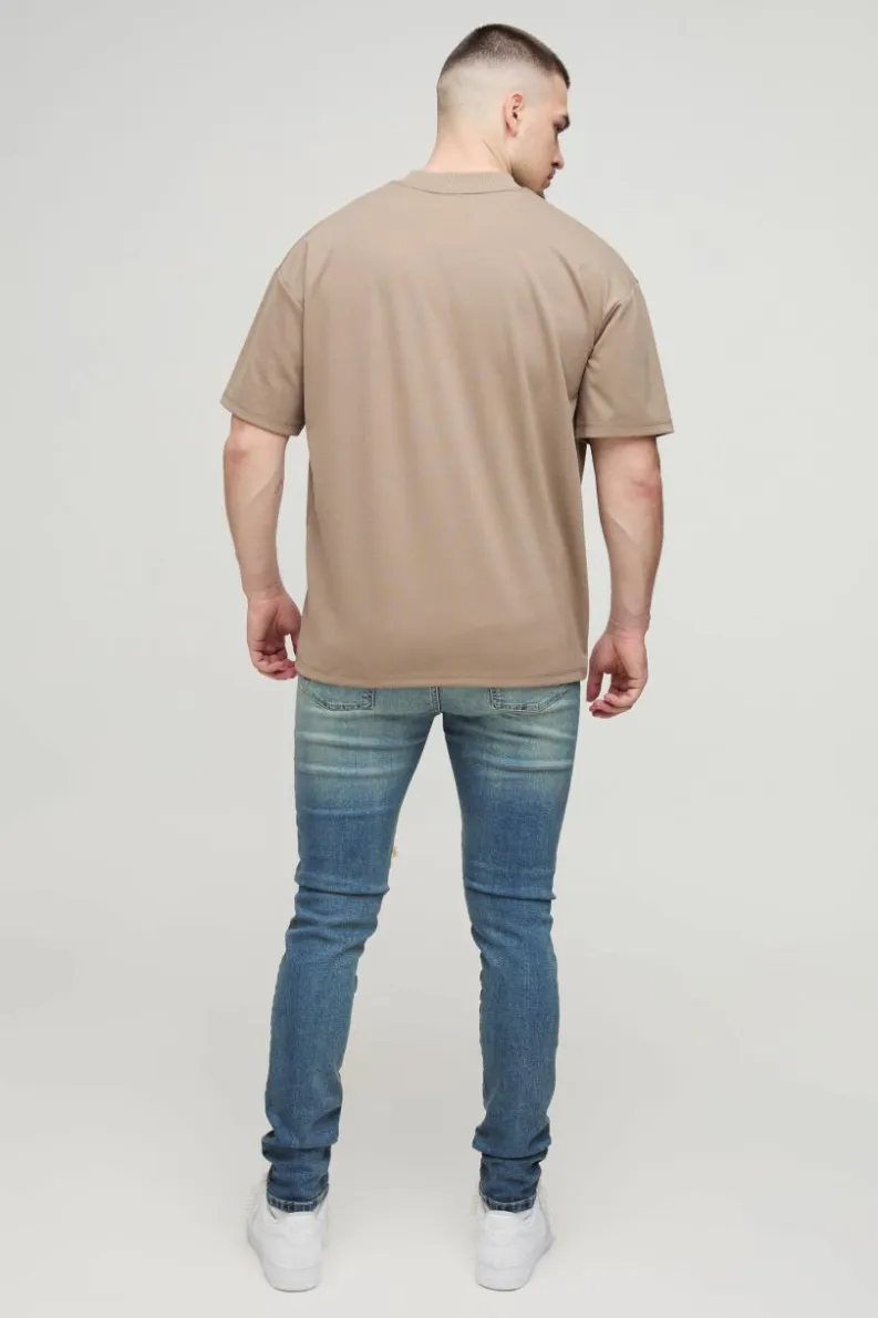 Shop boohooMAN Tall Extreme Rip Busted Knee Skinny Jeans mid wash