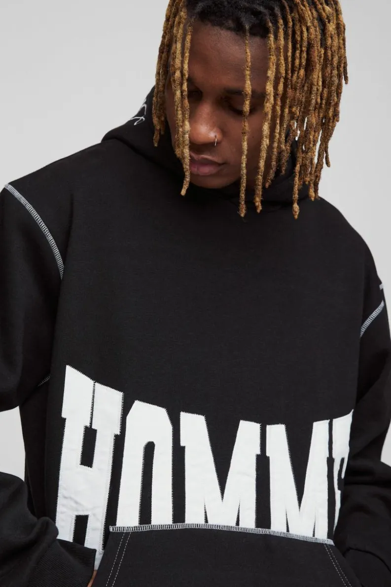 Shop boohooMAN Tall Oversized Boxy Twill Applique Contrast Stitch Hoodie black