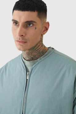 Store boohooMAN Tall Oversized Collarless Padded Bomber Jacket In slate