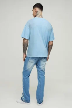 Shop boohooMAN Tall Star Applique Gusset Distressed Flared Jeans antique blue