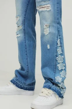 Shop boohooMAN Tall Star Applique Gusset Distressed Flared Jeans antique blue