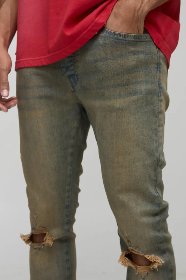 Store boohooMAN Tinted Rip Knee Stacked Skinny Zip Hem Jeans antique wash