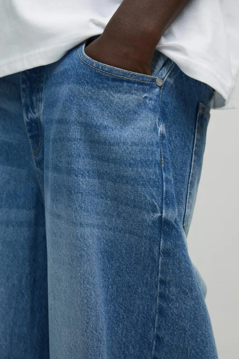 Shop boohooMAN Twist Seam Parachute Jeans light wash
