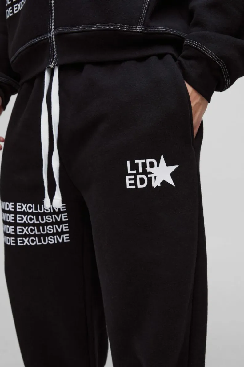 Shop boohooMAN Wide Leg Contrast Stitch Printed Joggers black