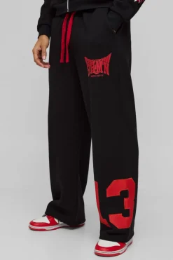 Shop boohooMAN Wide Leg Varsity Mesh Applique Jogger black